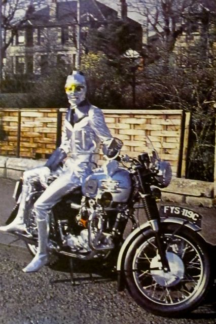 Magazine page with figure in silver leather leaning on motorcycle